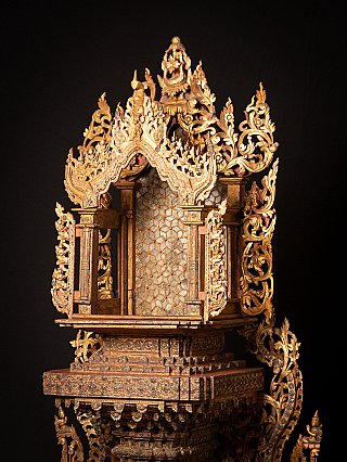 Upper structure of the wooden Burmese Buddha throne, angled side view of the open niche