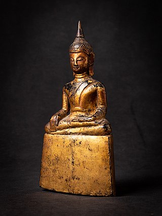 Wooden Thai Buddha statue seated, three-quarter left view with worn gilding