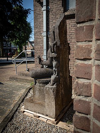 Indonesian lavastone Avalokiteshvara statue on plinth, angled side view showing the thick back slab