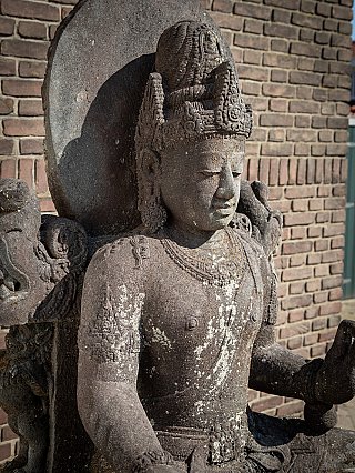 Head and upper torso detail of the Indonesian lavastone Avalokiteshvara, showing the tall crown