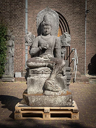 Avalokiteshvara lavastone statue from Indonesia, seated on base, full front view