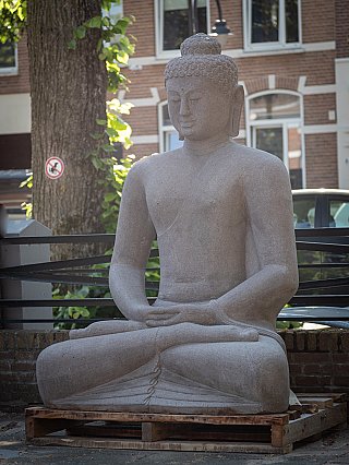 Indonesian lava stone Buddha statue with hands in lap, three-quarter right view