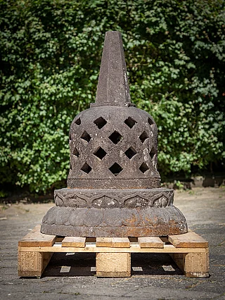 Indonesian lavastone stupa, full view with pierced body on a wooden pallet