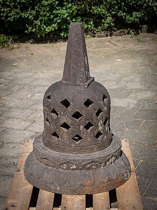 Lavastone stupa from Indonesia, three-quarter view with tall finial and cut-out openings
