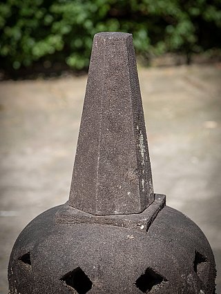 Top section of the Indonesian lavastone stupa, close-up of the finial above the dome