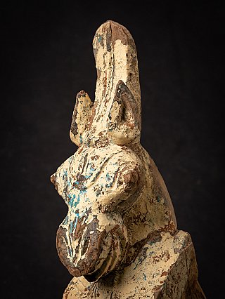 Detail of the horse head in angled side view, ear and chipped paint visible