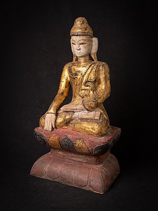 Shan Burmese Buddha statue in wood, seated, three-quarter right view with base