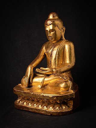 Burmese wooden Buddha statue on lotus base, seated, three-quarter left view