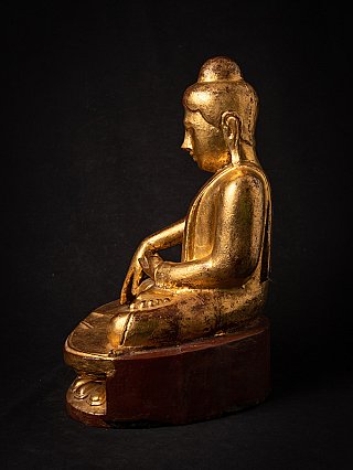 Burmese wooden Buddha statue seated on lotus base, left side view