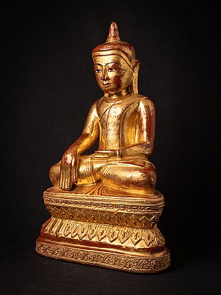 Wooden Burmese Buddha statue seated, three-quarter view showing the carved base