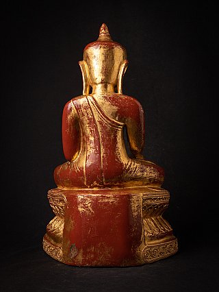 Wooden Burmese Buddha statue seated, rear view with red and gold finish