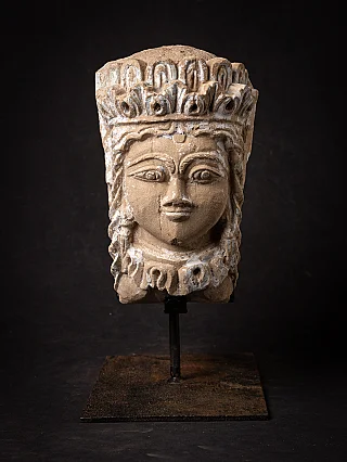 Antique head from India on metal stand, full front view with crown band and white paint traces