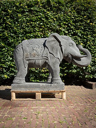 Lavastone elephant statue from Indonesia, right side view with curled trunk