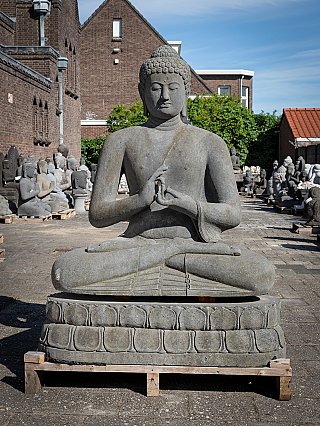 Buddha statue in Indonesian lavastone, seated on lotus throne, full front view with Dharmachakra mudra