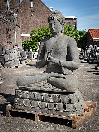 Buddha statue carved from lavastone, Indonesia, three-quarter view on lotus throne