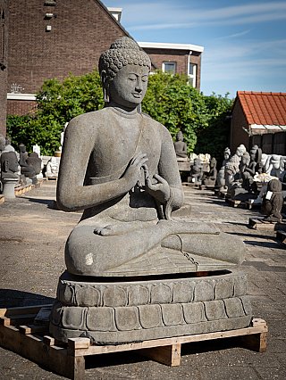 Lavastone Buddha statue from Indonesia, three-quarter view seated on lotus throne