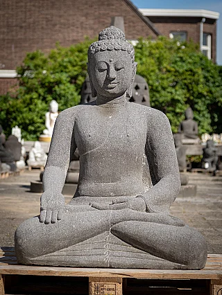 Buddha statue in Indonesian lavastone, full front view seated with varada mudra