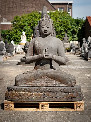 Large Indonesian lavastone Buddha statue on base, seated with Dharmachakra mudra, front view