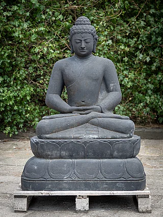 Buddha statue in Indonesian lavastone, seated in dhyana mudra on lotus base, full front view