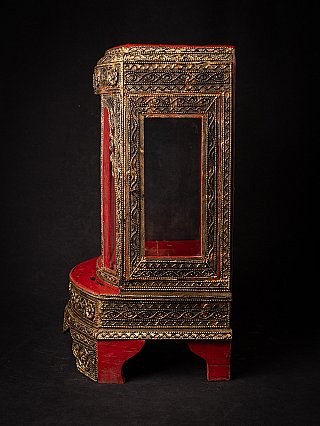 Antique wooden Burmese shrine, side view with rectangular glass window and gilded framing