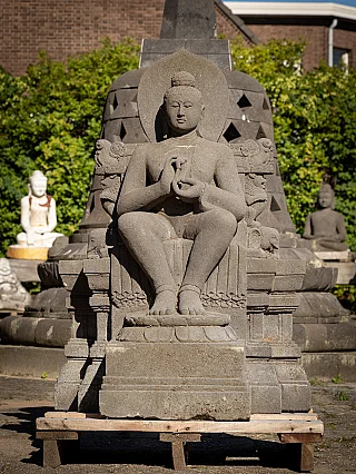 Buddha statue in Indonesian lavastone, seated with dharmachakra mudra, full front view