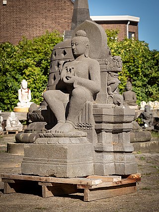 Buddha statue in Indonesian lavastone with dharmachakra mudra, three-quarter left view