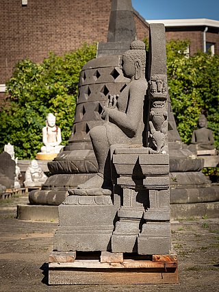Indonesian lavastone Buddha statue seated on a throne, left side profile with halo