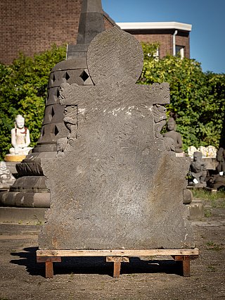 Rear view of the Indonesian lavastone Buddha statue showing halo and throne back