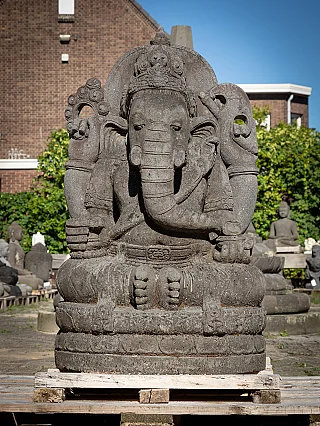 Ganesha statue in Indonesian lavastone, seated, full front view on a wooden pallet
