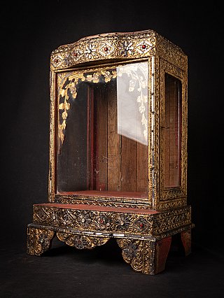 Burmese wooden temple shrine, three-quarter view showing side glass panel