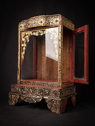 Burmese wooden shrine cabinet with glass front, three-quarter view with side door open