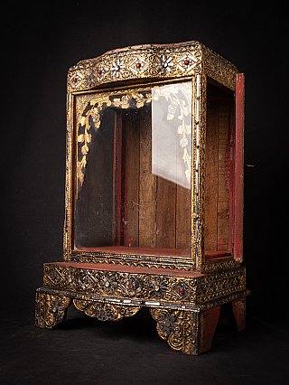 Antique Mandalay period temple shrine, angled view with red side door open