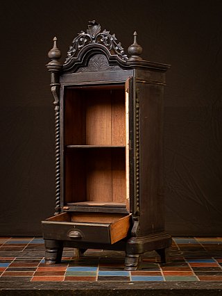 Wooden temple cabinet from Myanmar showing open interior shelves and ajar drawer, angled view