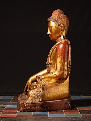 Seated wooden Buddha statue from Myanmar, side profile showing lowered right hand