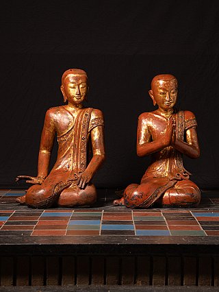 Burmese wooden monk statues from the Mandalay period, seated pair in full-front view