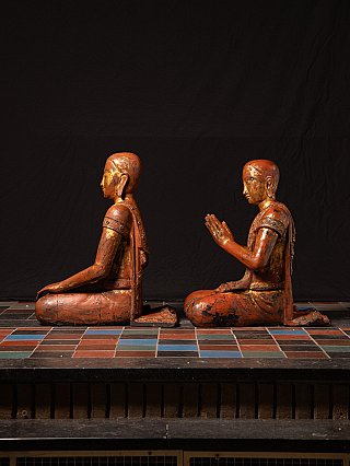 Burmese wooden monk statues, seated pair shown in side profile