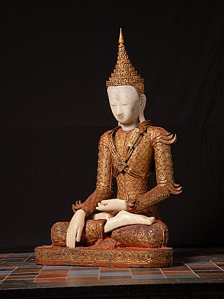 Buddha statue from Burma (Myanmar) in wood, seated three-quarter view showing crown and robe