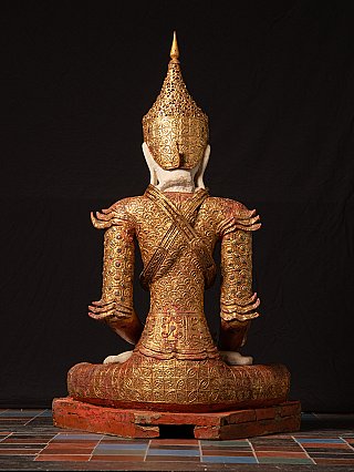 Burmese wooden Buddha statue rear view showing crossed straps and patterned robe