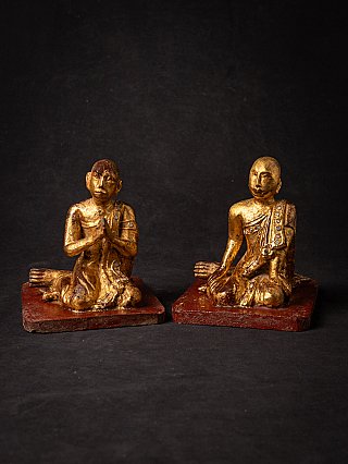 Pair of Burmese wooden monk statues on red bases, full front view