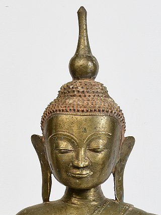 Front face detail of the Burmese bronze Buddha, with elongated earlobes and topknot