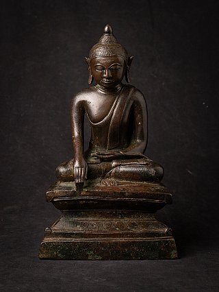 Burmese bronze Buddha statue in bhumisparsha mudra, seated on tiered base, full front