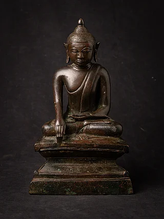 Burmese bronze Buddha statue in bhumisparsha mudra, seated on tiered base, full front