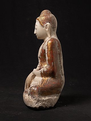 Seated Mandalay-style marble Buddha statue, left side profile with painted robe