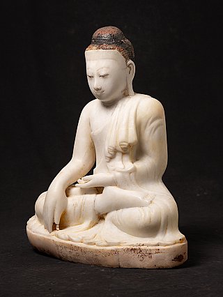 Marble Buddha statue from Myanmar in bhumisparsha mudra, three-quarter left view