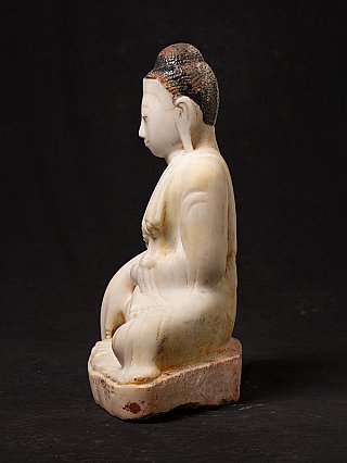 Seated marble Buddha statue from Burma, left side profile showing arm and earlobe