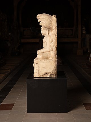 Marble Jain statue side profile showing the seated figure and projecting cobra hood