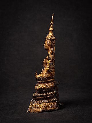Thai bronze Buddha statue, seated, side profile showing the tall crown and base