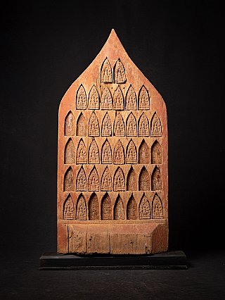 Antique wooden Burmese temple panel with rows of arched niches and small reliefs, front view