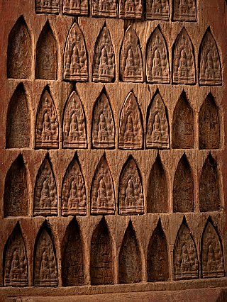 Detail of rows of arched niches with small relief figures on the wooden temple panel