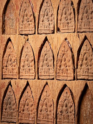 Detail showing multiple rows of niche reliefs with small gaps and edge wear